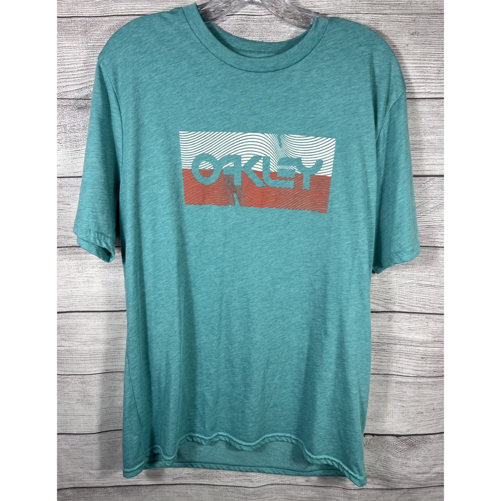 Oakley Buckle Exclusive Graphic Tee Shirt Mens Large Teal Blue Green Wavy Logo